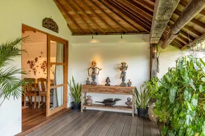 a room with plants and statues on the wall at Villa Tago - 5 BR Villa in Umalas in Kerobokan