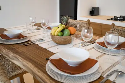 a wooden table with a bowl of fruit on it at Villa Casa Gaia 1 by BaliSuperHost in Umalas
