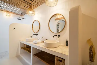 a bathroom with two sinks and two mirrors at Villa Casa Gaia 1 by BaliSuperHost in Umalas