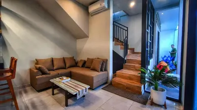 a living room with a couch and a table at Villa by BALIem in Jimbaran
