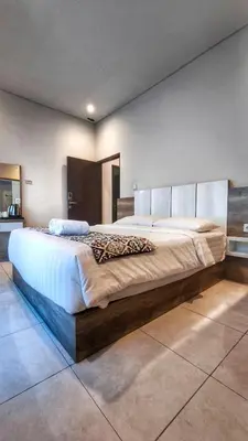 a bedroom with a large bed in a room at Villa by BALIem in Jimbaran