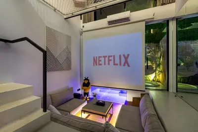 a living room with a netflix sign on the wall at Alex Villas Complex N5 in Canggu