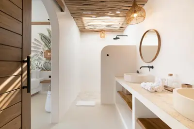 a bathroom with two sinks and a mirror at Villa Casa Gaia 5 by BaliSuperHost in Kerobokan