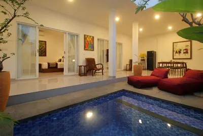 a house with a swimming pool and a living room at Bougainvillea Villa Seminyak by Parigata in Seminyak