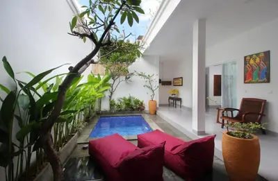 a living room with a swimming pool in a house at Bougainvillea Villa Seminyak by Parigata in Seminyak