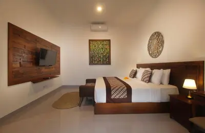 a bedroom with a bed and a flat screen tv at Bougainvillea Villa Seminyak by Parigata in Seminyak
