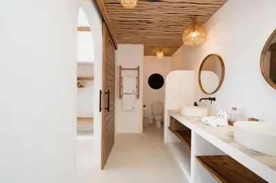 a bathroom with two sinks and a mirror at Villa Casa Gaia 6 by BaliSuperHost in Kerobokan