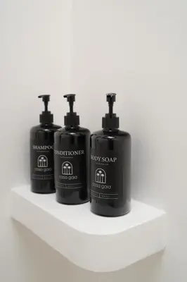 three bottles of soap sitting on a shelf at Villa Casa Gaia 6 by BaliSuperHost in Kerobokan
