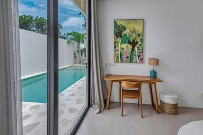 a dining room with a table and a pool at New Magnificent 3BR 5min to Finns & Berawa Beach Villa Alemar in Canggu