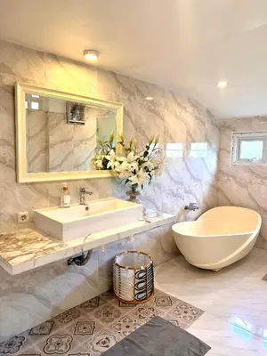 a bathroom with a sink and a large mirror at Greenhouse Villa in Kerobokan