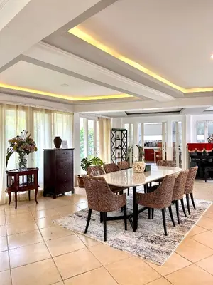 a dining room with a table and chairs at Greenhouse Villa in Kerobokan