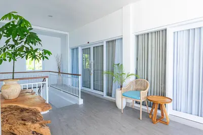 a room with a table and a chair on a balcony at Tirta Mumbul Villa in Badung