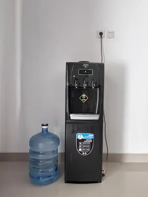 a bottle of water next to a water dispenser at Louise villa in Jimbaran