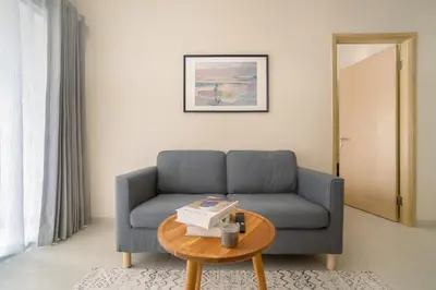 a living room with a couch and a table at Bali Bustle Sunset Coliving and Coworking Space in Legian