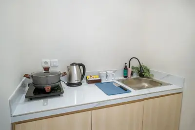 a kitchen counter with a pot and a sink at Bali Bustle Sunset Coliving and Coworking Space in Legian