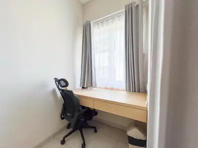 a desk with a chair in front of a window at Bali Bustle Sunset Coliving and Coworking Space in Legian