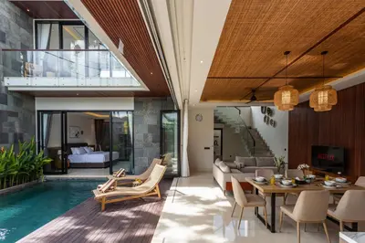 an open living room with a pool and a house at Trendy Modern and Spacious 3Bd Villa in Umalas in Kerobokan