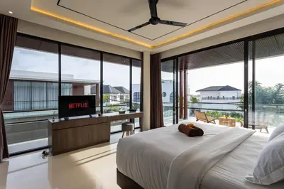 a bedroom with a large bed with a television in it at Luxury Chic 3bd Modern Villa in Umalas in Kerobokan