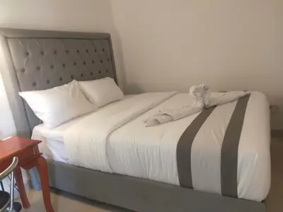 a bedroom with a bed with a headboard at Carstenzs Home Kuta in Kuta