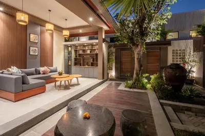 a living room with a couch and a table at The New Moon Umalas in Seminyak