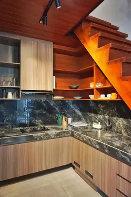 a kitchen with wooden cabinets and a sink at The New Moon Umalas in Seminyak