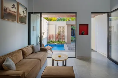 a living room with a couch and a table at The New Moon Umalas in Seminyak