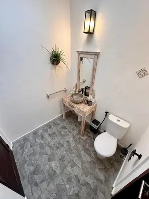a bathroom with a toilet and a sink and a mirror at The Getaway Villa Seminyak Bali in Seminyak