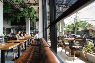 a view of a restaurant with tables and chairs at Amazing Garden Room with Private Pool at Anwa Bali in Canggu