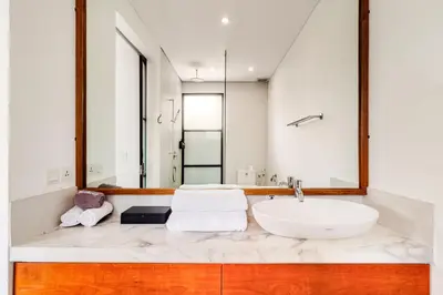 a bathroom with a sink and a mirror at Amazing Garden Room with Private Pool at Anwa Bali in Canggu