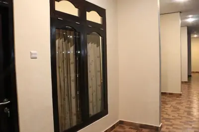 a room with a door with a mirror on the wall at Chillin Kuta Homestay in Kuta
