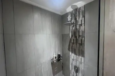 a bathroom with a shower with a sink and a shower at Ranala Coliving in Seminyak
