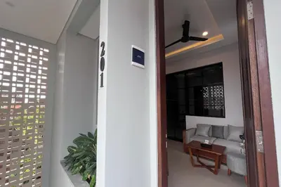a living room with a couch and a ceiling fan at Ranala Coliving in Seminyak