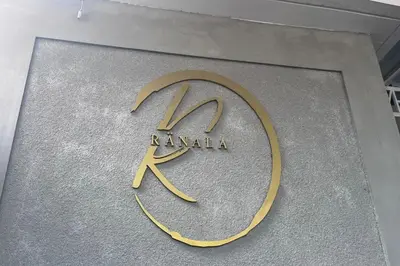 a sign on a building with the name karma at Ranala Coliving in Seminyak