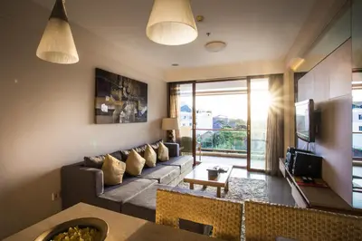 a living room with a couch and a table at Kuta Reef Apartments in Kuta