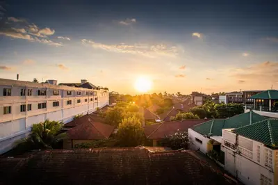 a view of a city with the sunset in the background at Kuta Reef Apartments in Kuta