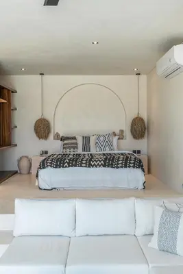 a bedroom with a large bed and a couch at Casa Vera - Delightful 1-Bedroom Villas in the Heart of Umalas in Canggu