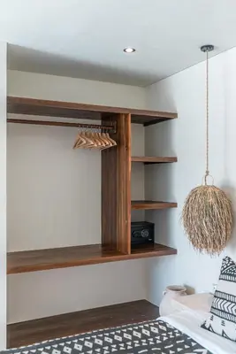 a room with wooden shelves and a bed at Casa Vera - Delightful 1-Bedroom Villas in the Heart of Umalas in Canggu