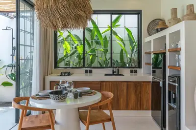 a kitchen with a table and chairs and a window at Casa Vera - Delightful 1-Bedroom Villas in the Heart of Umalas in Canggu