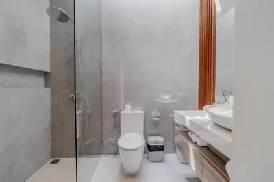 a bathroom with a shower and a toilet and a sink at Casa Estella Stunning 2BR in Umalas Canggu in Kerobokan