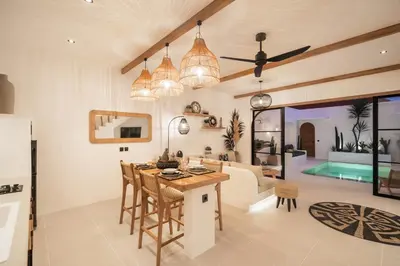 a kitchen and living room with a table and chairs at Villa Casa Gaia 3 by BaliSuperHost in Kerobokan