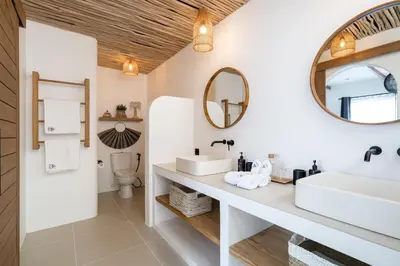 a bathroom with two sinks and a mirror at Villa Casa Gaia 4 by BaliSuperHost in Kerobokan