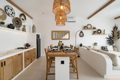 a kitchen with a table and chairs and a counter at Villa Casa Gaia 4 by BaliSuperHost in Kerobokan