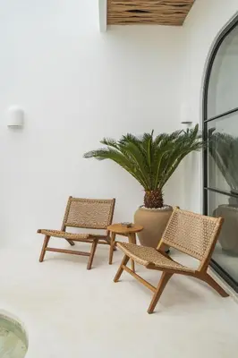 two rattan chairs and a table and a potted plant at Villa Casa Gaia 4 by BaliSuperHost in Kerobokan