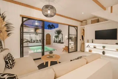 a living room with a couch and a tv at Villa Casa Gaia 4 by BaliSuperHost in Kerobokan