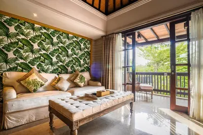 a living room with a couch and a wall of plants at The Springs Villas Jimbaran in Jimbaran