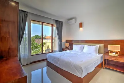 a bedroom with a bed and a large window at PRIVATE 3BR - Yash Villa at Seminyak in Kerobokan