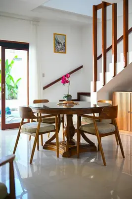 a dining room with a wooden table and chairs at PRIVATE 3BR - Yash Villa at Seminyak in Kerobokan