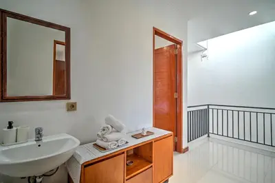a white bathroom with a sink and a mirror at PRIVATE 3BR - Yash Villa at Seminyak in Kerobokan