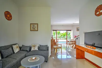 a living room with a couch and a flat screen tv at PRIVATE 3BR - Yash Villa at Seminyak in Kerobokan
