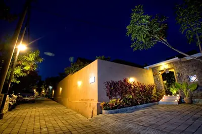 a night view of a building with a street light at Villa Cokelat in Canggu